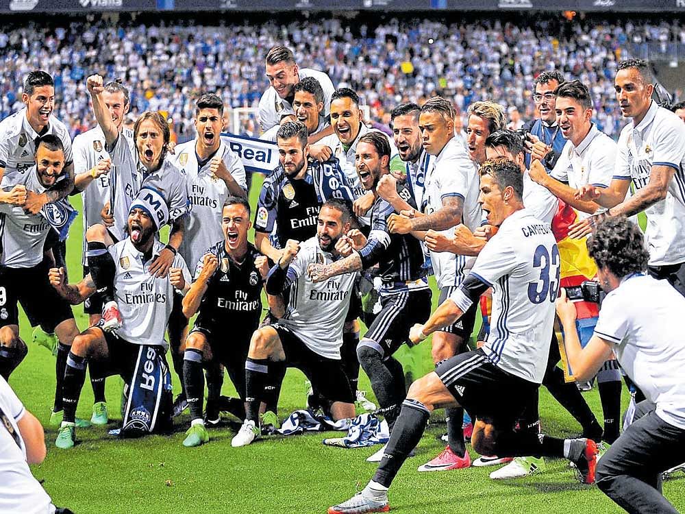 Champions: Real Madrid players are a delighted lot after clinching the La Liga title in Malaga on Sunday. AFP