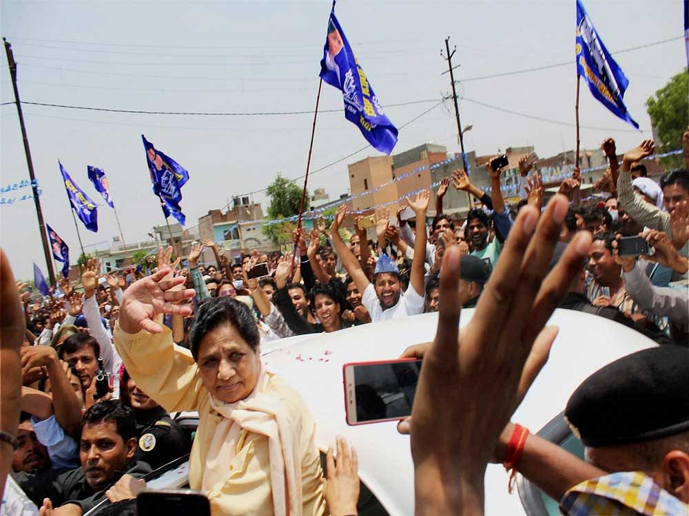 BSP President Mayawati waves at supporters on her arrival in Meerut on Tuesday on her way to violence-hit Saharanpur. PTI Photo