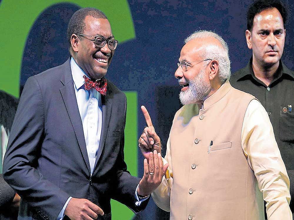 in a lighter vein: Prime Minister Narendra Modi shares a moment with African Development Bank president  Akinwumi Adesina during the inauguration ceremony of the Annual General Meeting of the AfDB bank in Gandhinagar on  Tuesday. REUTERS