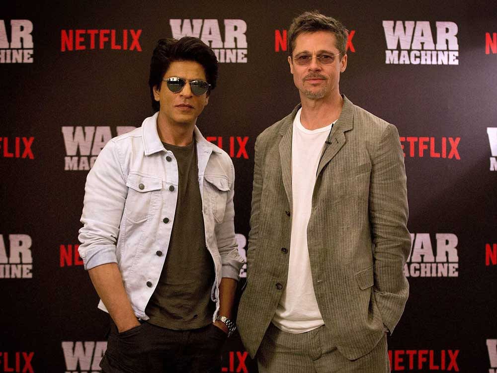 Hollywood actor Brad Pitt with Bollywood actor Shah Rukh Khan at the Oberoi Trident Towers in Mumbai to promote Brad Pitt's Netflix satire 'War Machine' which is releasing on May 26. PTI Photo