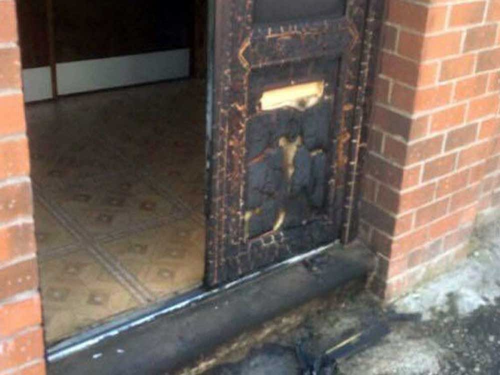 A few hours after the Manchester concert attack an unidentified figure was caught on CCTV attempting to set fire to the door of a mosque in Oldham. Above: Doors of mosque in Oldham. Photo credit Facebook.