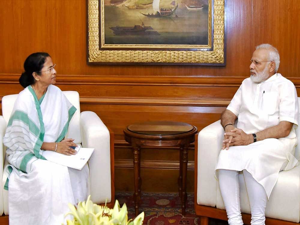 Prime Minister Narendra Modi with Chief Minister of West Bengal, Mamata Banerjee in New Delhi on Thursday. PTI Photo