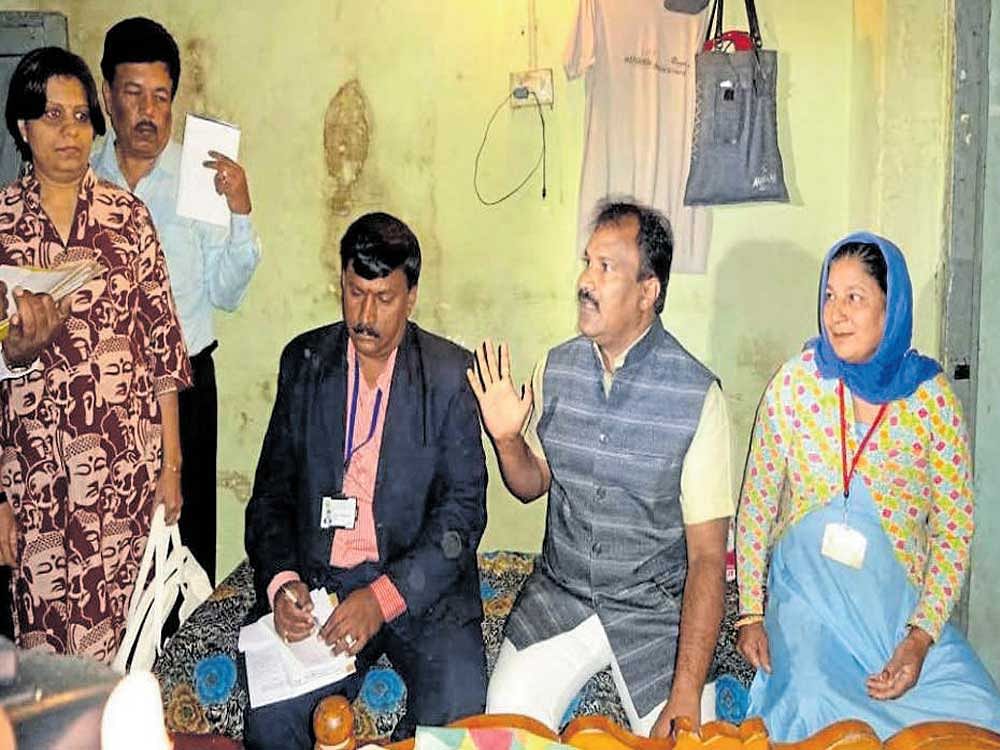 Karnataka State Safai Karmachari Commission Chairman M R Venkatesh pays a visit to the house of a civic worker in Ranipet in Madikeri on Friday. DH photo