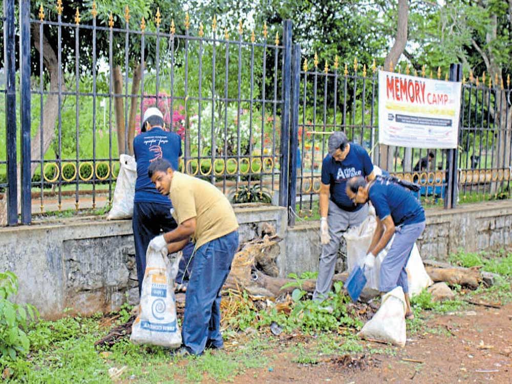 Volunteers remove garbage from Kadri Park Road.