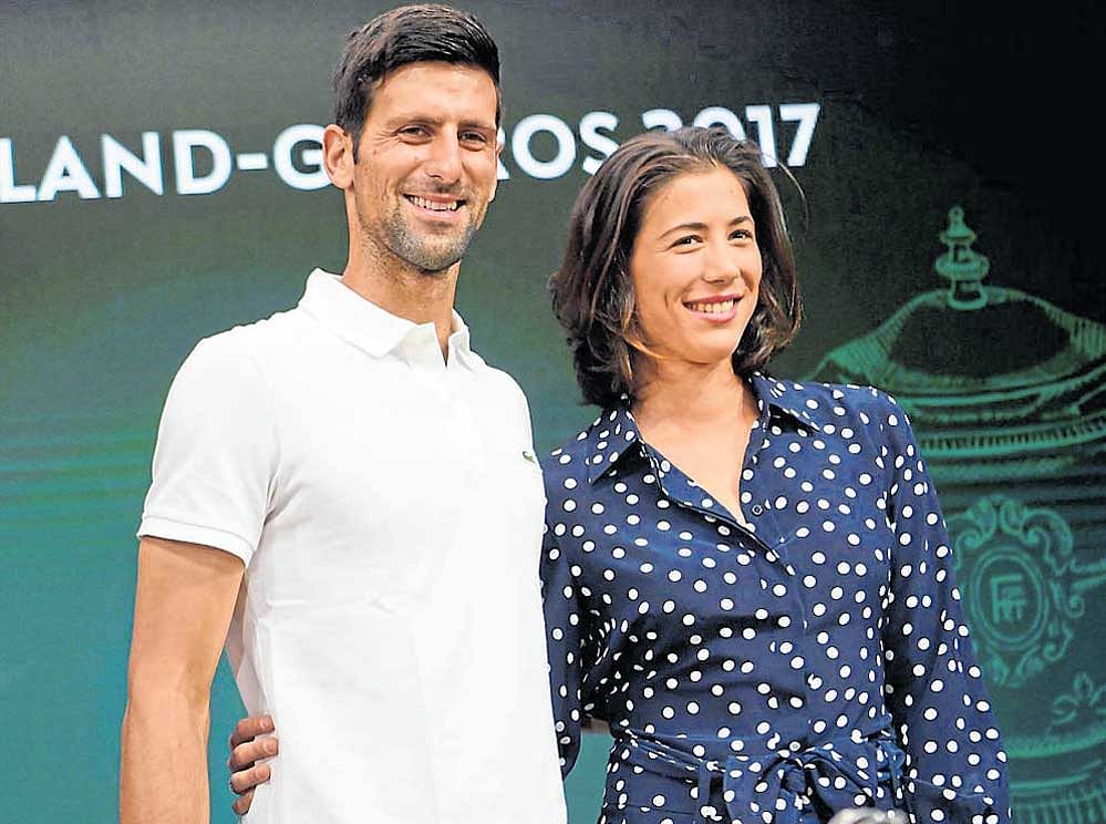 all set for defence: French Open defending champions Novak&#8200;Djokovic (left) and Garbine Muguruza at the draw ceremony in Paris on Friday. AFP