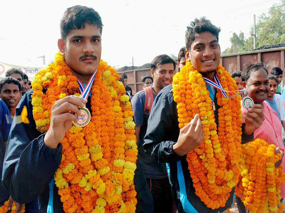 Rohit Yadav (left) was placed under suspension and has had his silver medal taken from him for testing positive for a banned substance. Photo credit: PTI.