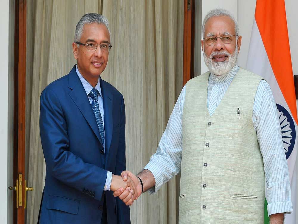 Prime Minister Narendra Modi shakes hand with his Mauritius counterpart Pravind Kumar Jugnauth at the Hyderabad House in New Delhi on Saturday. PTI Photo