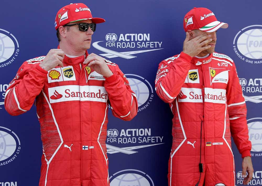 Formula One - F1 - Monaco Grand Prix - Monaco - 27/05/2017 - Ferrari's Kimi Raikkonen (L) stands next Sebastian Vettel after taking the pole position in qualifying session. Reuters photo.