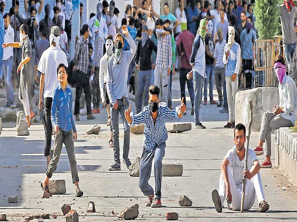 Demonstrators hurl stones and shout pro-freedom slogans during a protest in Srinagar on Saturday. Reuters