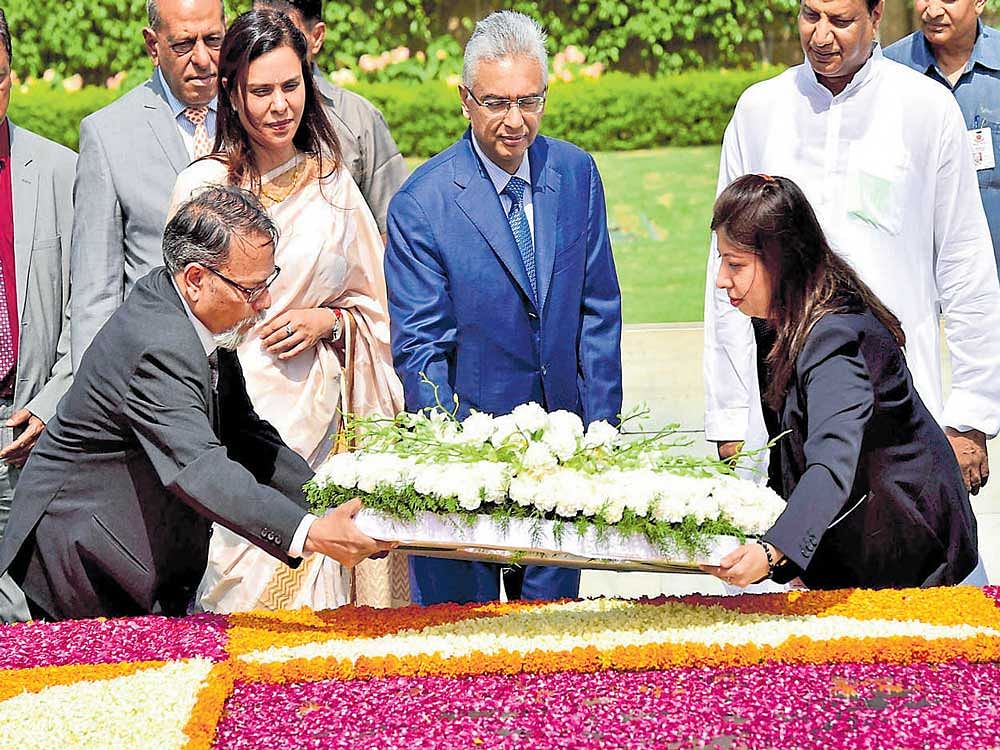 Prime Minister of the Republic of Mauritius Pravind Kumar Jugnauth places a wreath at Rajghat in New Delhi on Saturday. PTI