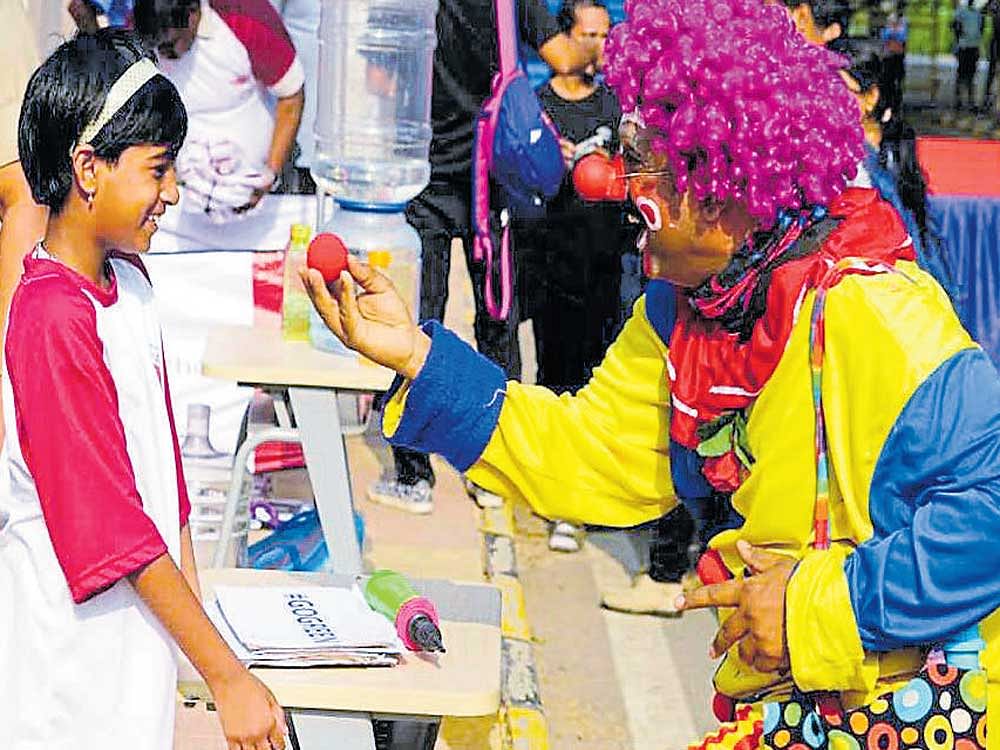 Dressed as a clown, Tharanath G entertains a child at St John's hospital in Bengaluru. He is part of a group of volunteers called Humanitario Clowns which is spreading cheer among  terminally ill patients in the city.