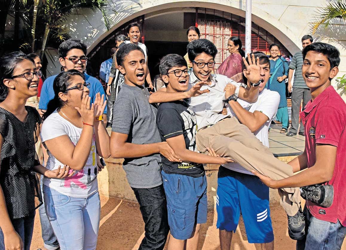 Friends celebrate with Ashwin Rao, who scored 99.4% in ICSE examinations, on Monday. He is the student of St Paul's English School, JP Nagar, Bengaluru. DH Photo