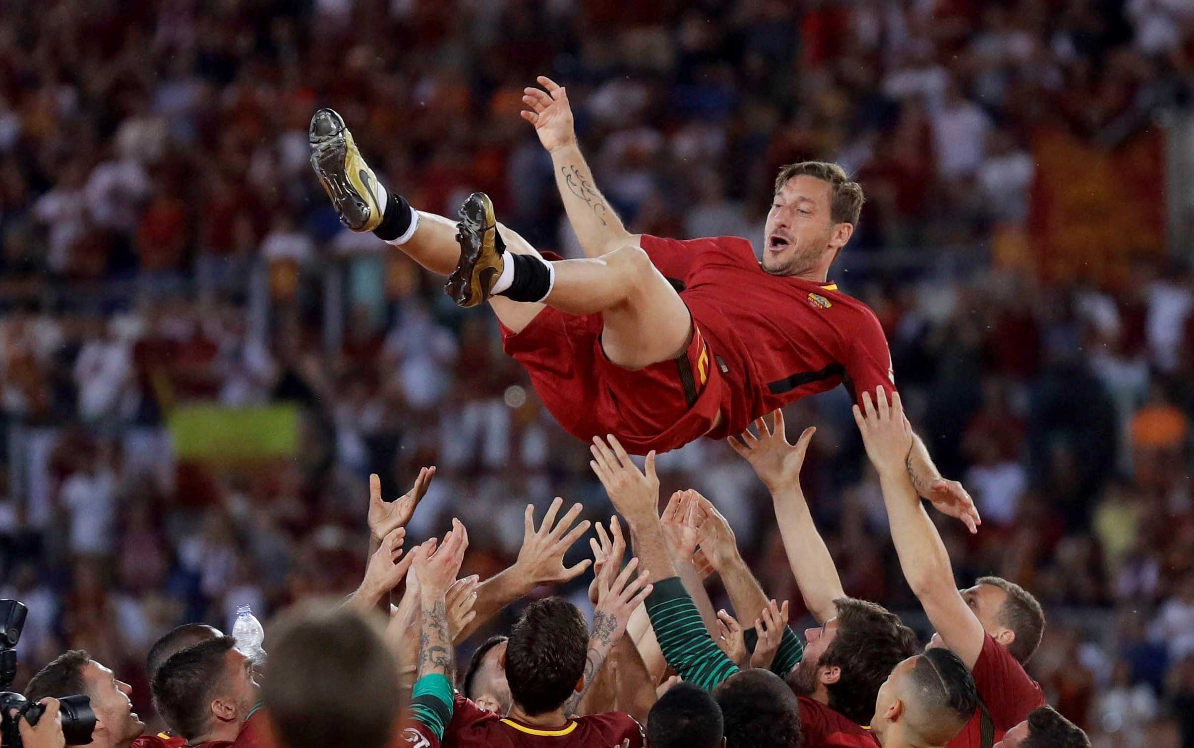 AS Roma players throw Francesco Totti  up in the air after his last match for the team. AP/PTI Image.