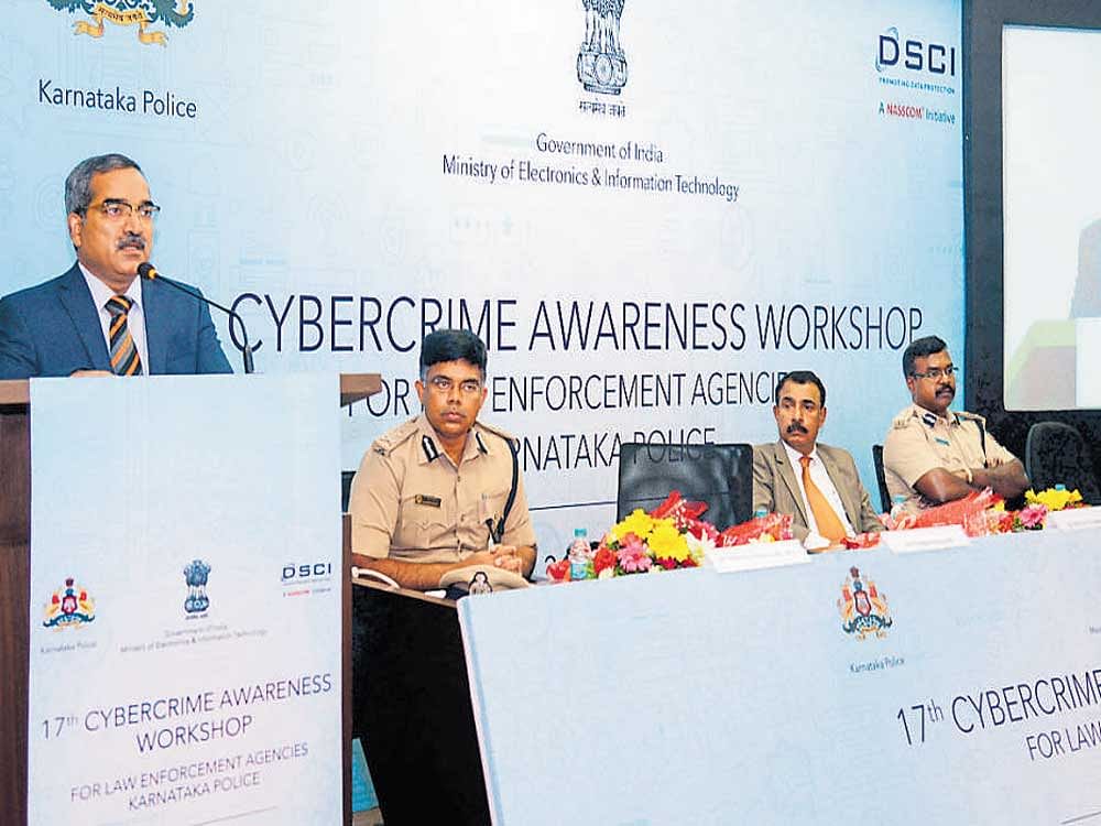 ADGP Prathap Reddy addresses a gathering at the cybercrime awareness workshop for law enforcement agencies in Mangaluru on Tuesday. City Police Commissioner M Chandra Sekhar, DGP (CID) Kishore Chandra and IGP (Western Range) P Harishekaran look on. DH photo