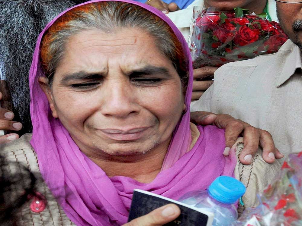 Sukhwant Kaur, 55, arrives at the Amritsar airport from Saudi Arabia on Wednesday. She came five months after allegedly sold as a slave by a dubious travel agent.PTI Photo
