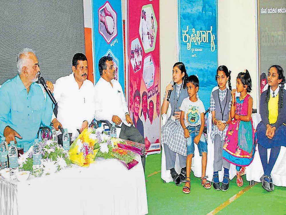 District in-charge Minister A Manju interacts with students during the 'Jana Mana' programme in Hassan on Wednesday.