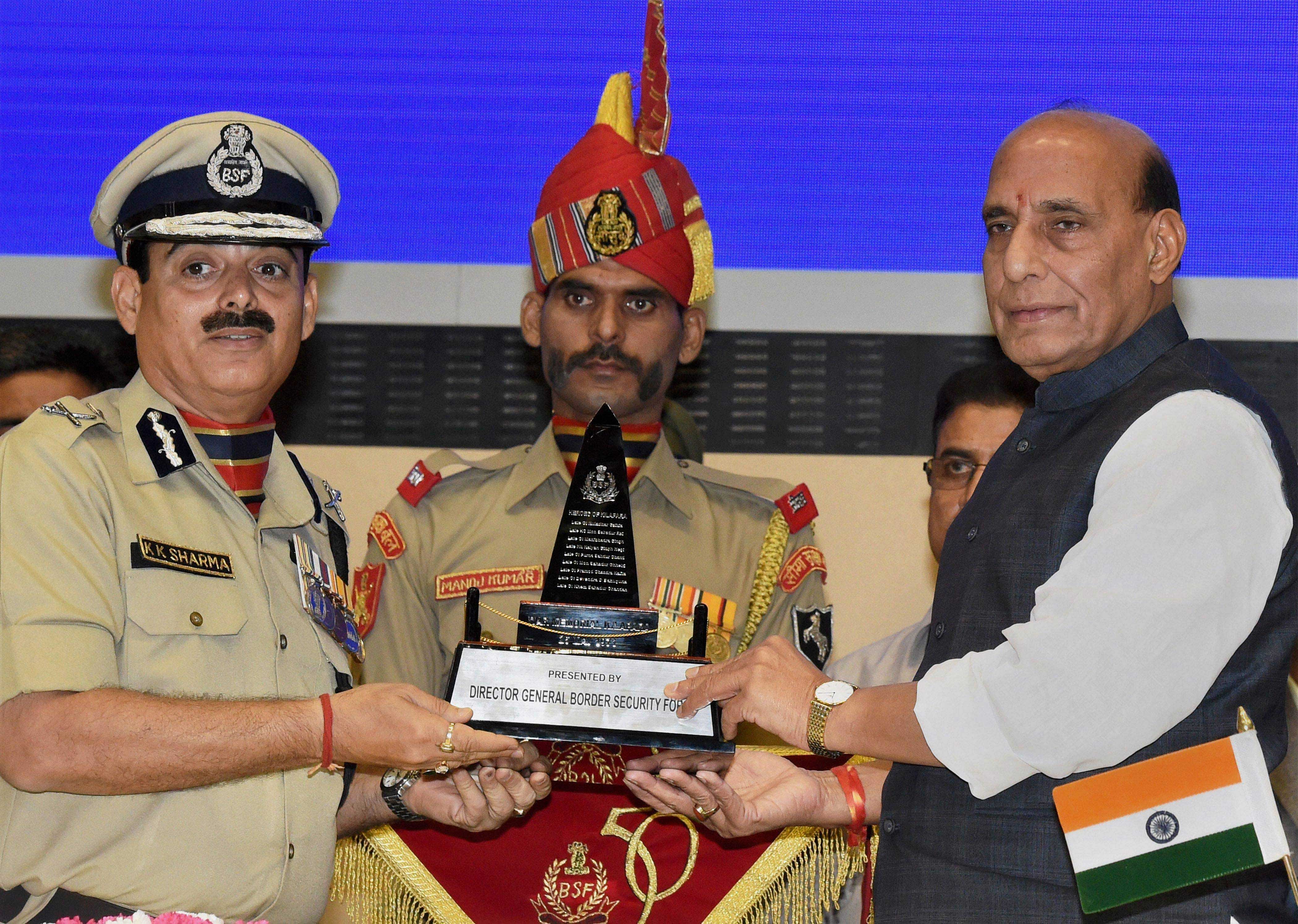 New Delhi: Union Home Minister Rajnath Singh being received a memento from Director General of Border Security Force (BSF) K K Sharma at the 15th BSF investiture ceremony in New Delhi on Thursday.PTI  photo.