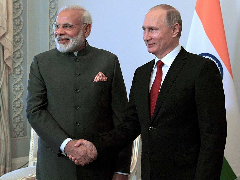 Russian President Vladimir Putin, right, shakes hands with India's Prime Minister Narendra Modi prior their talks at the St. Petersburg International Economic Forum in St. Petersburg, Russia, Thursday, June 1, 2017. Modi's visit to Russia comes amid he and other world leaders expressed commitment to fighting climate change after U.S. President Donald Trump indicated that the U.S. might pull out of the Paris climate accords. AP/PTI Photo