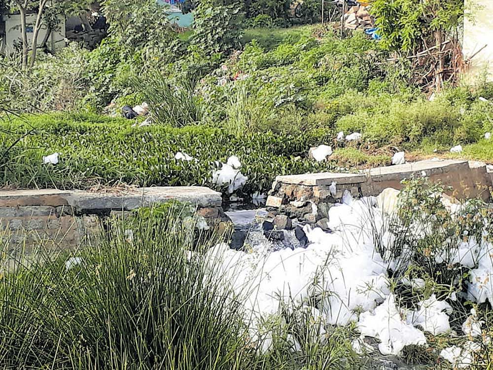 Water flows out of Subramanyapura lake after its waste weir was damaged on Thursday night.