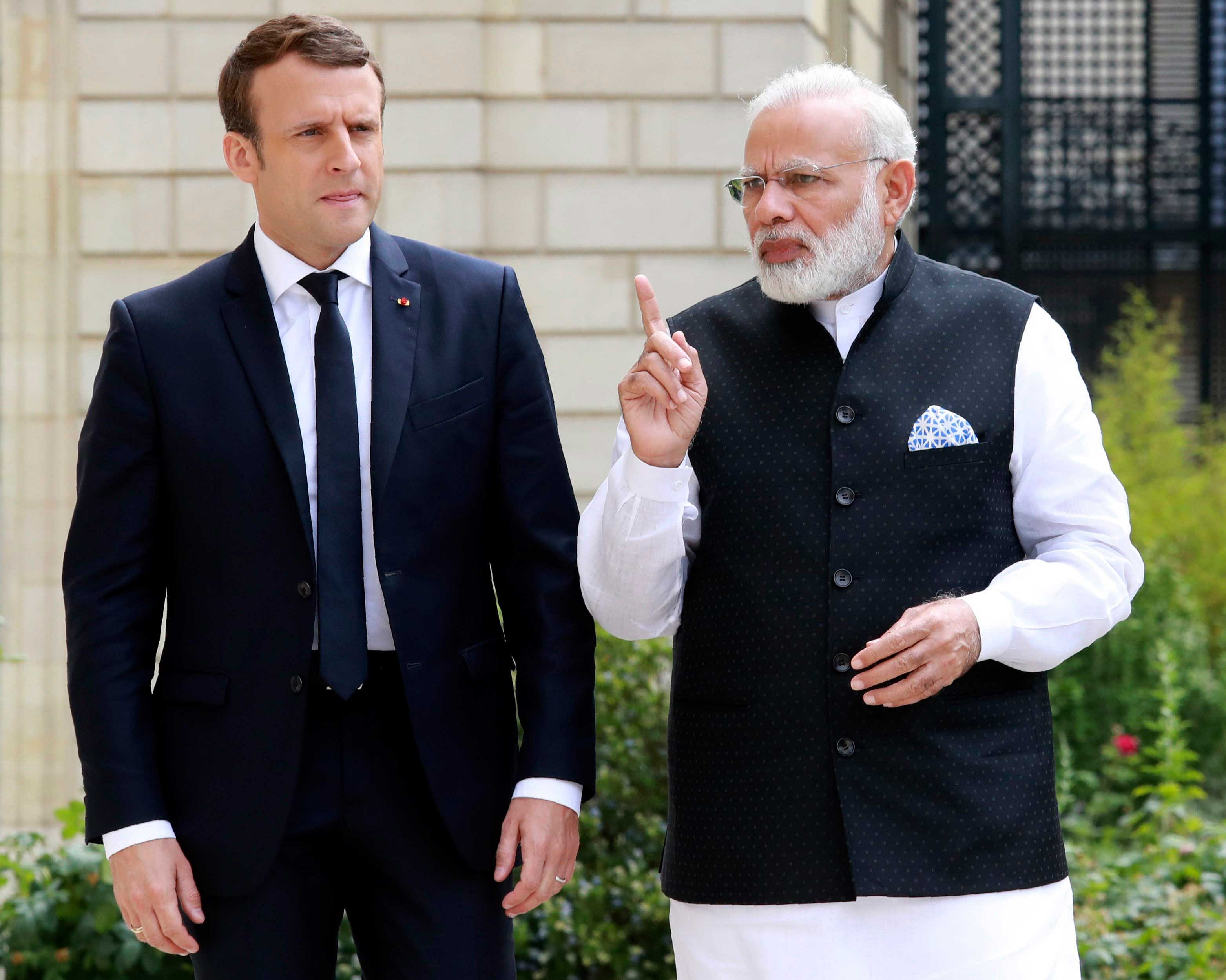 ndian Prime Minister Narendra Modi (R) speaks with French President Emmanuel Macron in the garden of the Elysee Palace following their meeting in Paris, France, June 3, 2017. Reuters image
