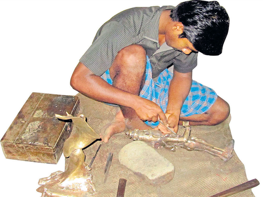 temple treasures: A 'sthapathy' making a bronze idol. photos by author