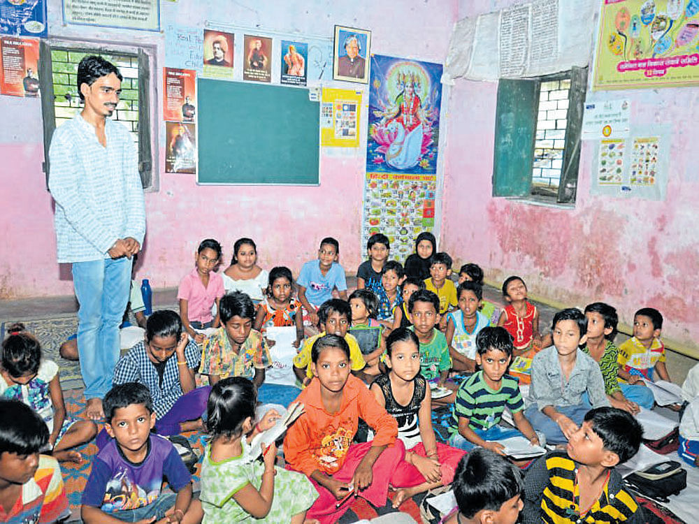 Rishikesh teaching underprivileged children at the community school, Gyanshala, in Patna. Mohan Prasad