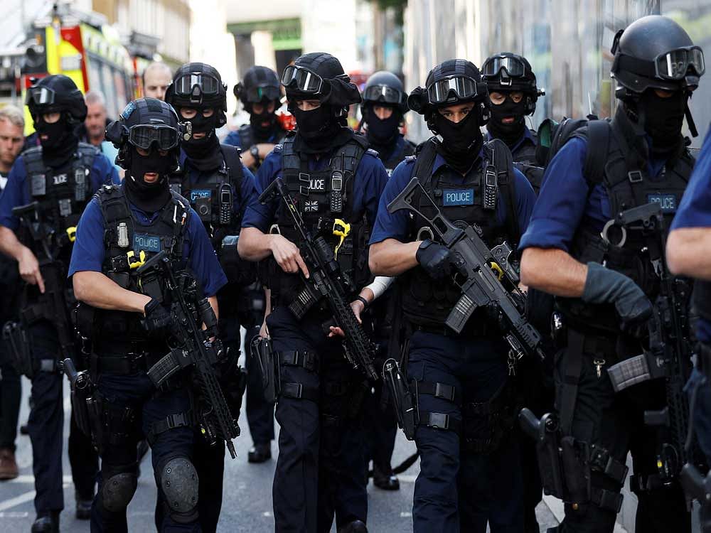 Armed police officers walk near Borough Market after an attack left 7 people dead and dozens injured in London, Britain, June 4, 2017. REUTERS