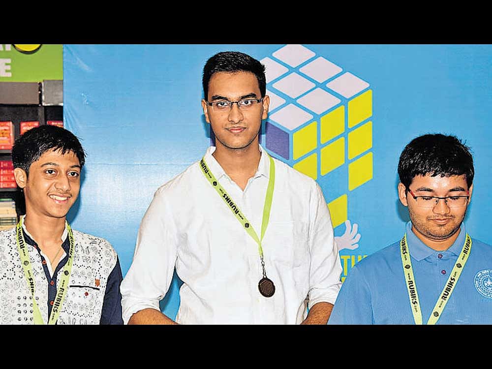 Mahesh Menon (centre) who bagged rubix cube championship held in the city on Sunday. Rohan Kammat (left) and Rishab Tanhane (right) secured second and third places respectively. dh photo