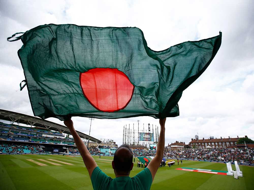 A fan with a Bangladesh flag as the teams line up for national anthems. Reuters photo