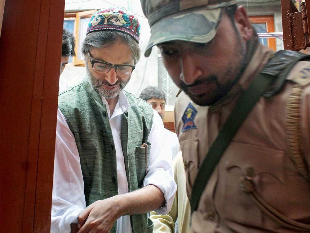 Police detain JKLF chairman Yasin Malik as he was heading for a separatists' meeting in Srinagar on Monday. PTI