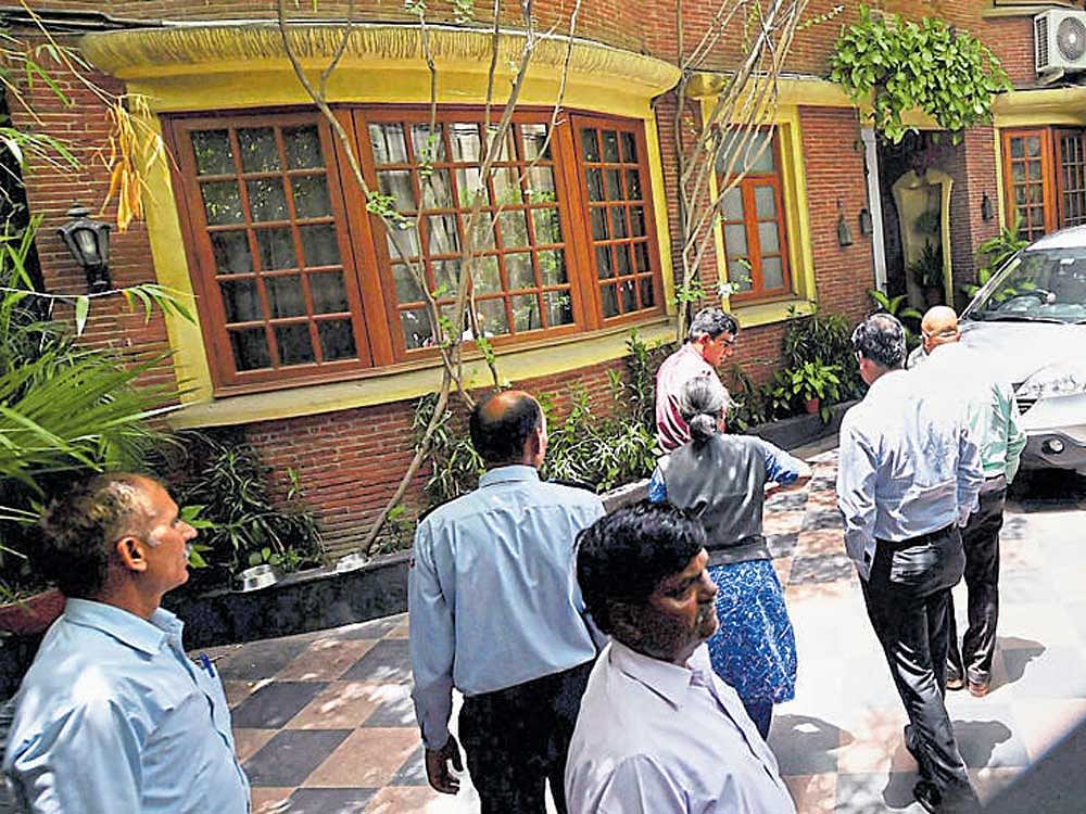 CBI sleuths at the residence of Prannoy Roy, one of the  news channel's promoters, in New Delhi on Monday. PTI