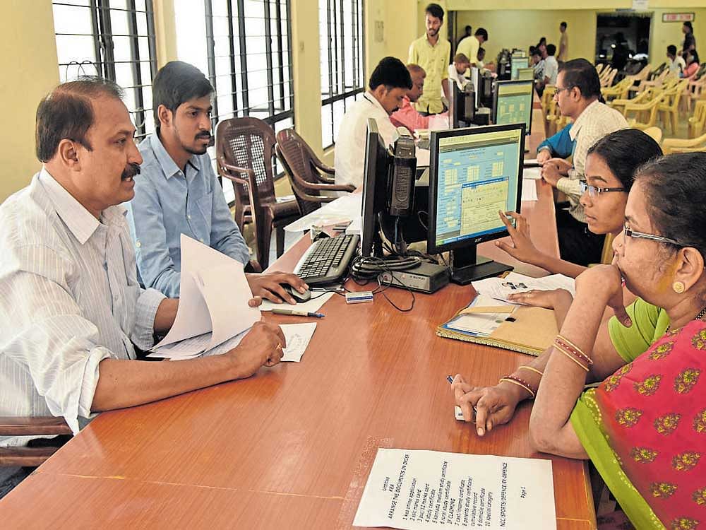 Officials check the documents of a student attending the CET&#8200;engineering counselling at the Karnataka Examinations Authority (KEA) on Monday. dh Photo