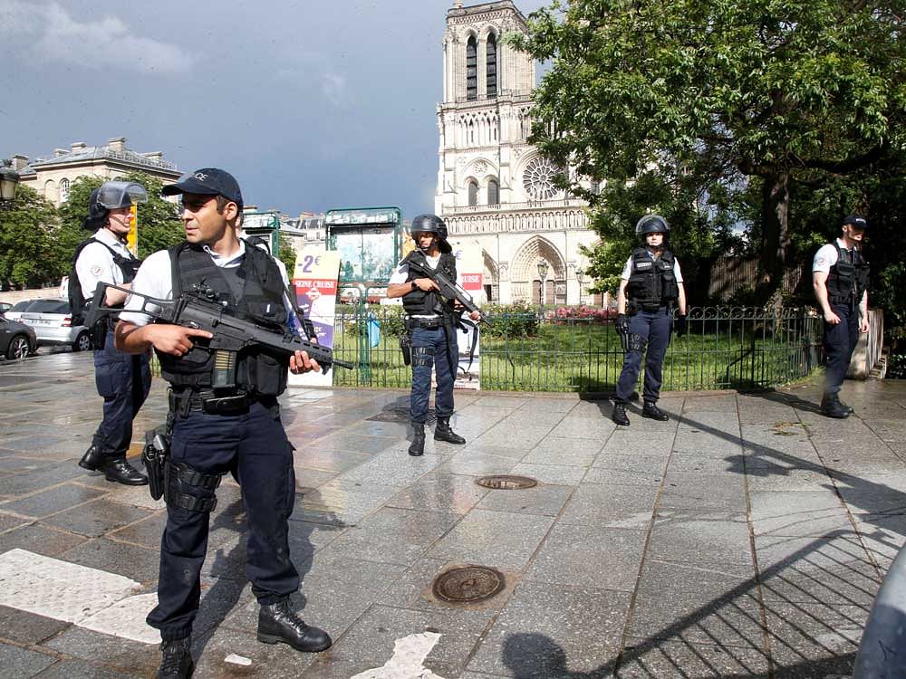 French police stand at the scene of a shooting incident near the Notre Dame Cathedral in Paris, France. REUTERS Photo
