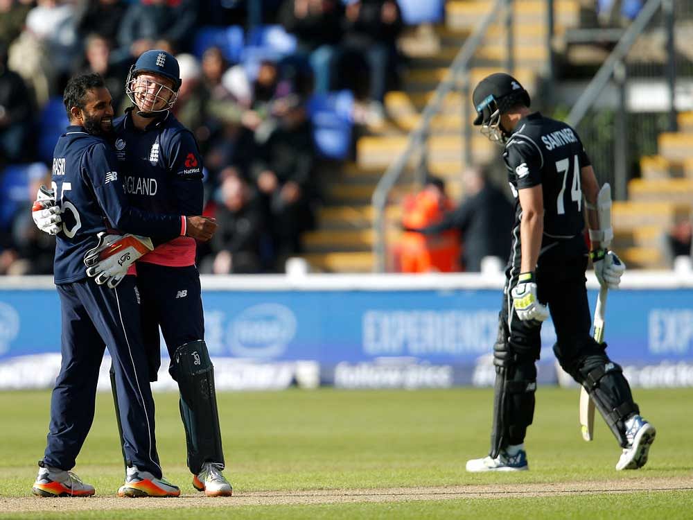 England's Jos Buttler and Adil Rashid celebrate the wicket of New Zealand's Mitchell Santner. Reuters Photo