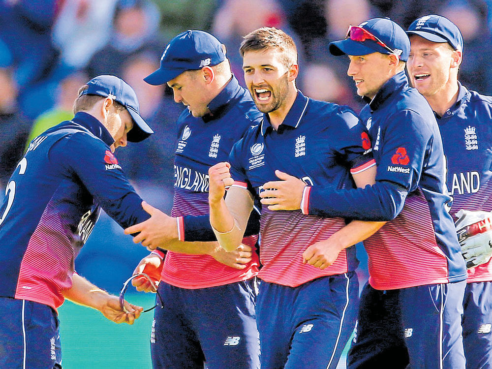 big wicket: England's Mark Wood (centre) celebrates after dismissing New Zealand skipper Kane Williamson. Reuters
