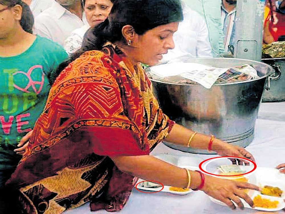 another controversy: Minister Swati Singh distributes  Rs 100 notes (circled) along with eatables.