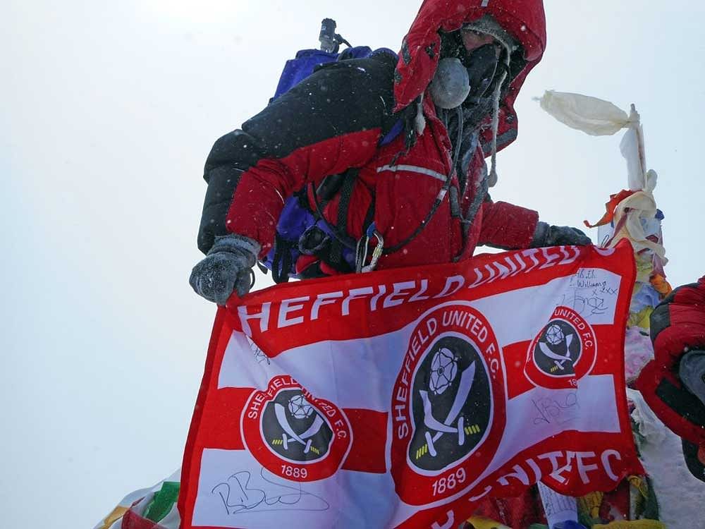 Ian Toothill, the Sheffield Wednesday Football Club fan, who has been told he has just months to live, planted a flag of rivals Sheffield United at the summit for charity. Image courtesy: Twitter
