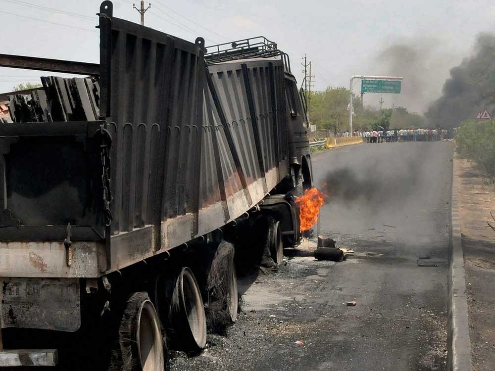 Farmers' agitation turns violent as they torch trucks at Highway in Mandsaur district of Madhya Pradesh on Wednesday. PTI Photo