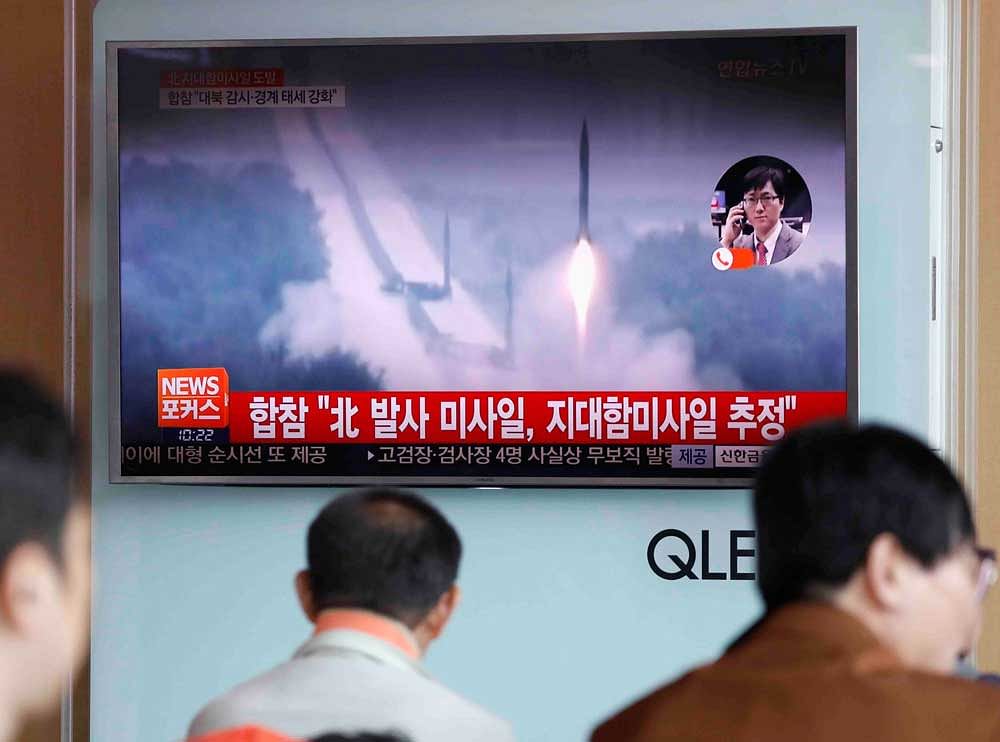 People watch a TV broadcast of a news report on North Korea firing what appeared to be several land-to-ship missiles off its east coast, at a railway station in Seoul, South Korea, June 8, 2017. REUTERS
