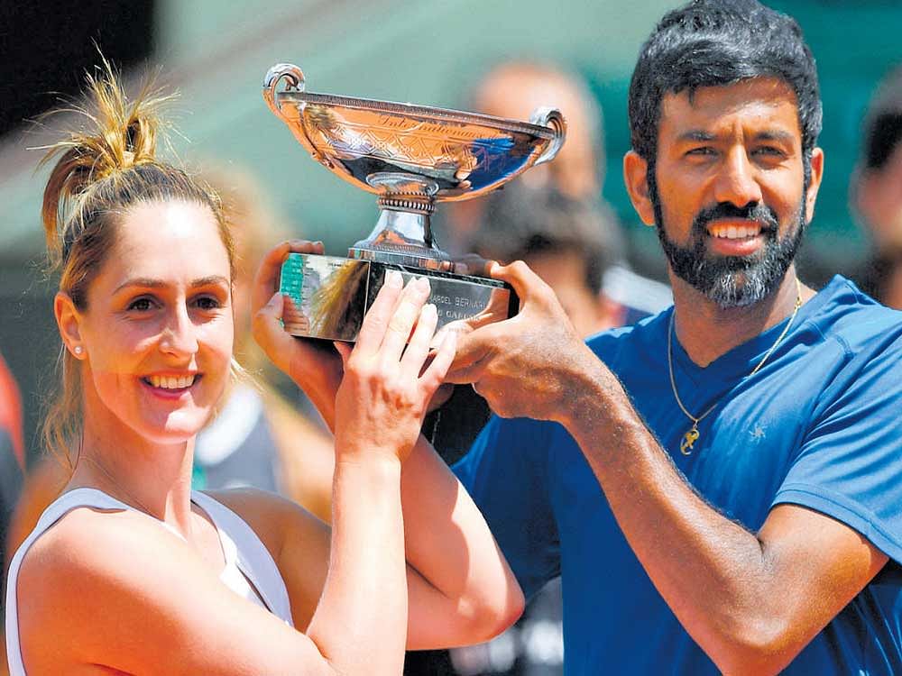 Canada's Gabriela Dabrowski (left) and Rohan Bopanna with their trophy after winning the French Open mixed doubles title at the Roland Garros on Thursday in Paris. AFP