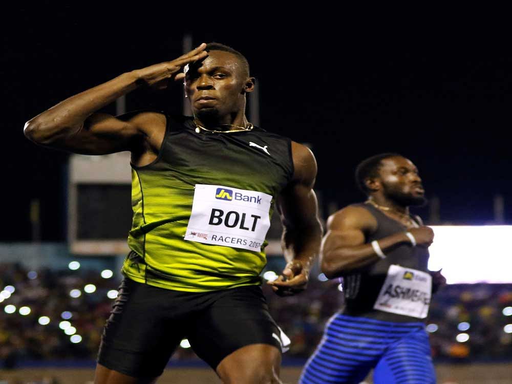 Jamaica's Olympic champion Usain Bolt (L) gestures after winning his final 100 meters sprint at the 2nd Racers Grand Prix at the National Stadium in Kingston, Jamaica June 10, 2017. REUTERS