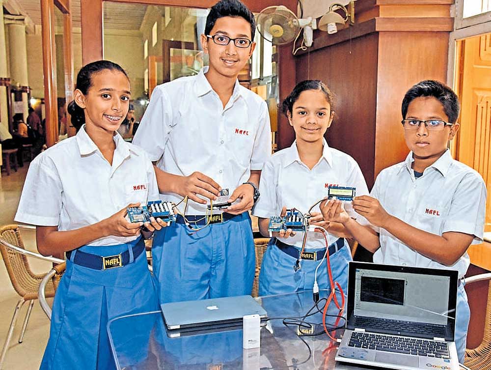 Amulya Doss, Arnav Mayur, Amisha Pai and Sreysht Prakash from the National Academy for Learning (NAFL) show AirEye, the device invented by them that can measure the air quality of any place. DH Photo/S K Dinesh