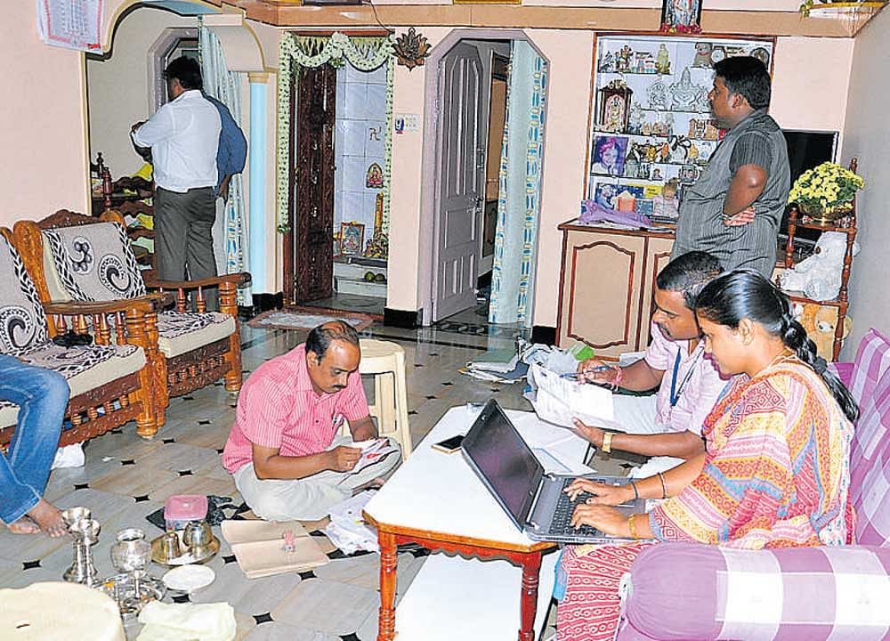 The officials of Anti Corruption Bureau search the house of N&#8200;Venkataramanappa, a hostel warden, in Chikkaballapur on Friday. DH photo