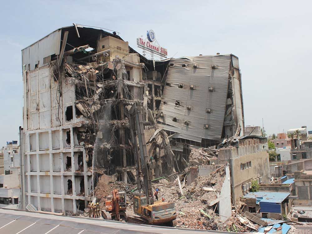 Major portion of the multi-storied Chennai Silks building, which was ravaged by major fire recently, collapsed on Saturday morning when workers were involved in demolishing the structure. Deccan Herald photo