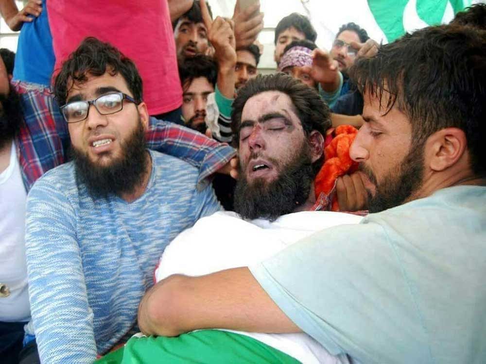 Eyewitnesses said at least five militants of both Lashkar-e-Toiba (LeT) and Hizb-ul-Mujahideen appeared in the funeral of slain commander Junaid Mattoo in Khudwani village of Anantnag in South Kashmir and offered a 'gun salute'  with young men and women rejoicing as pro-freedom and anti-India slogans filled the air. Picture courtesy Twitter