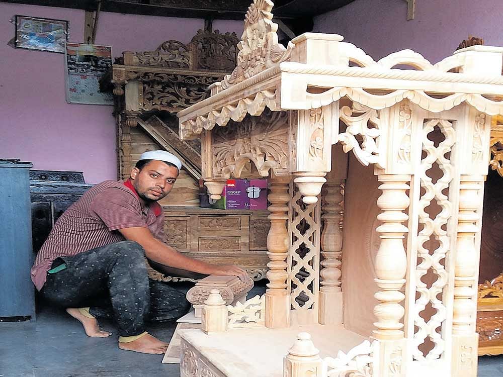 Mohammad Tarakshan works on a Pooja Mandir at his workshop at  Bowenpally in Hyderabad. Photo by JBS Umanadh