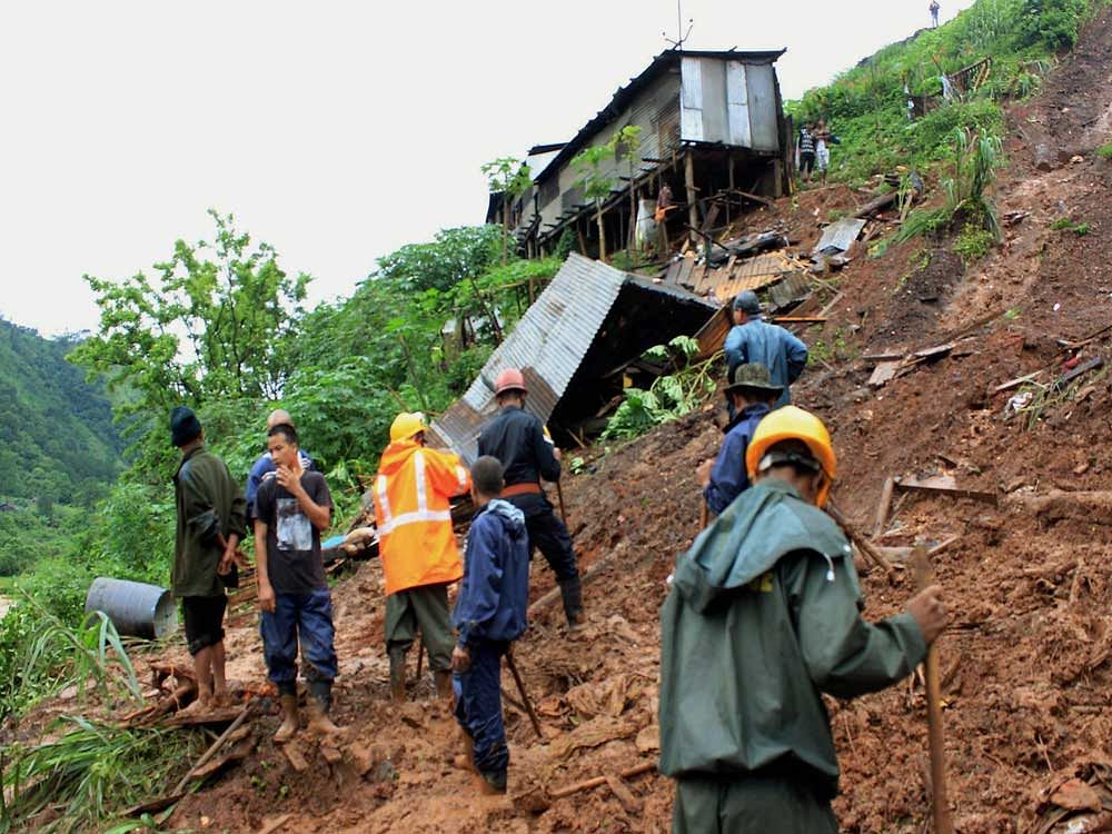 Rescue work in progress after a landslide Tharia village under Umiam Police Station in Meghalaya district due to heavy rains on Saturday. PTI Photo