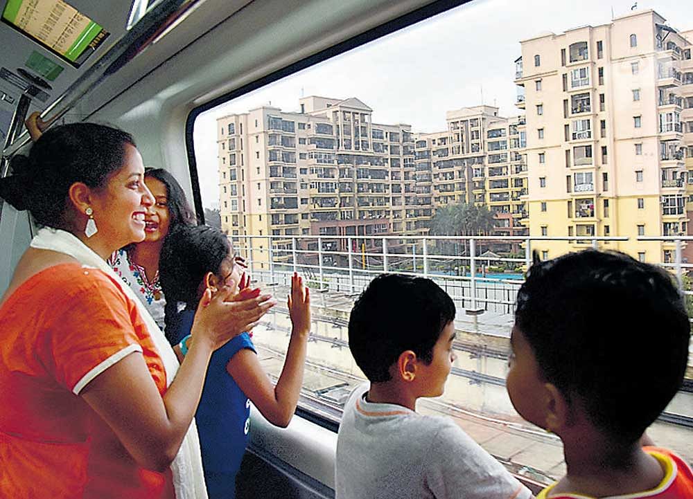 Commuters enjoy a ride in the Namma Metro between Yelachenahalli and  Nagasandra, which was thrown open to public on Sunday. dh Photo