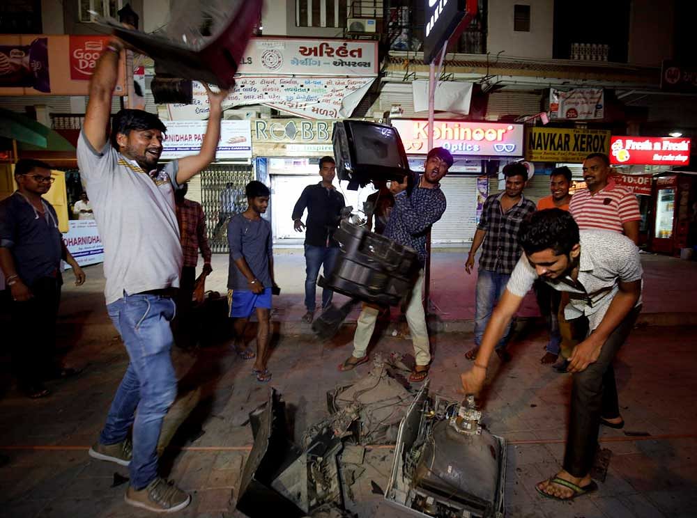 Cricket fans break television sets after India lost the match against Pakistan, in Ahmedabad on Sunday. PTI Photo