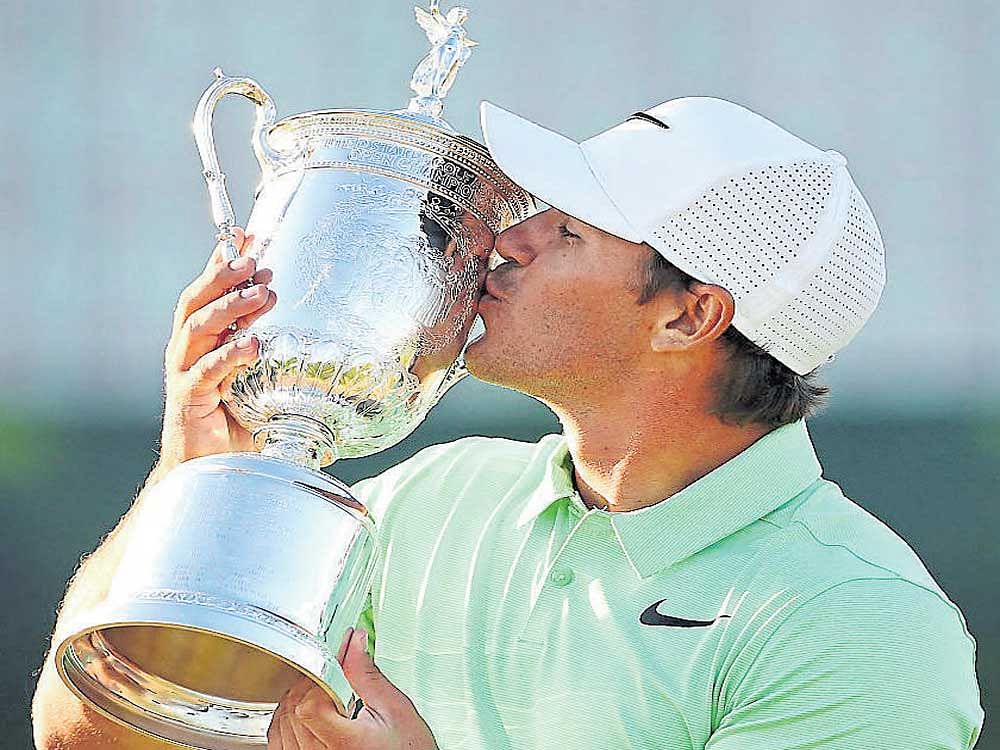 turning major: Brooks Koepka with the US Open trophy on Sunday. AFP